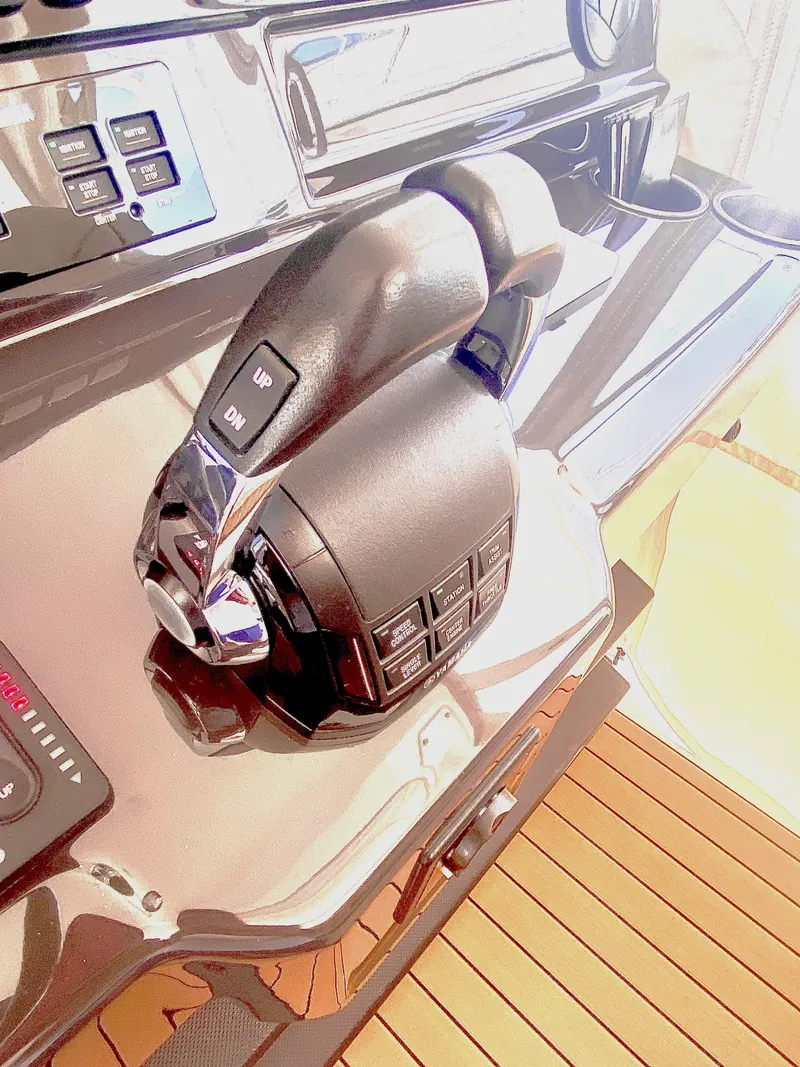 Slide: The Image of Throttle controls on 2019 Pursuit S 408 Sport boat dashboard. - 26