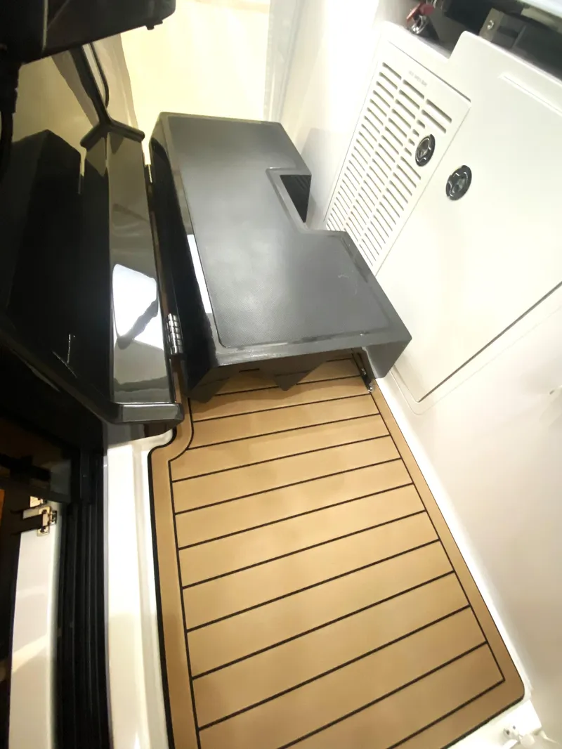 Slide: The Image of 2019 Pursuit S 408 Sport boat interior with teak flooring and storage compartments. - 27