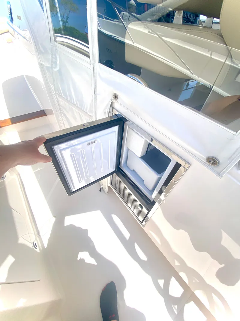 Slide: The Image of 2019 Pursuit S 408 Sport boat with open built-in ice maker. - 29