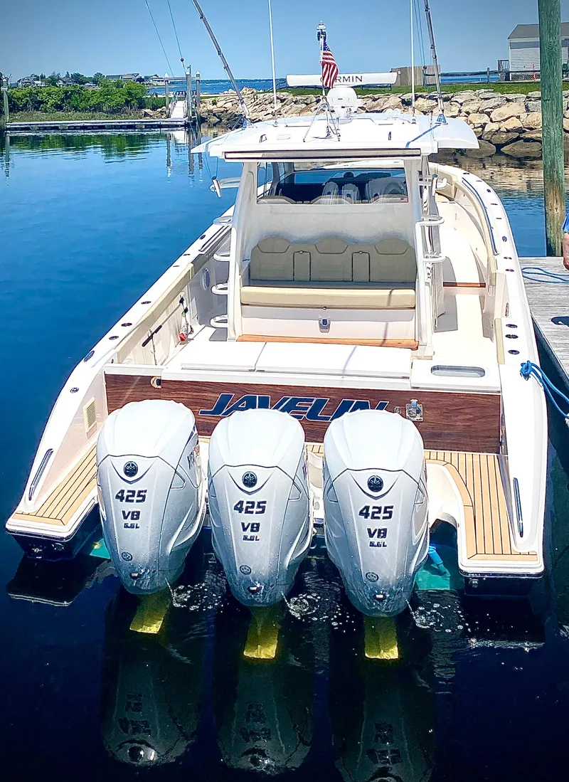 Slide: The Image of 2019 Pursuit S 408 Sport boat with triple 425 V8 engines docked in a marina. - 3