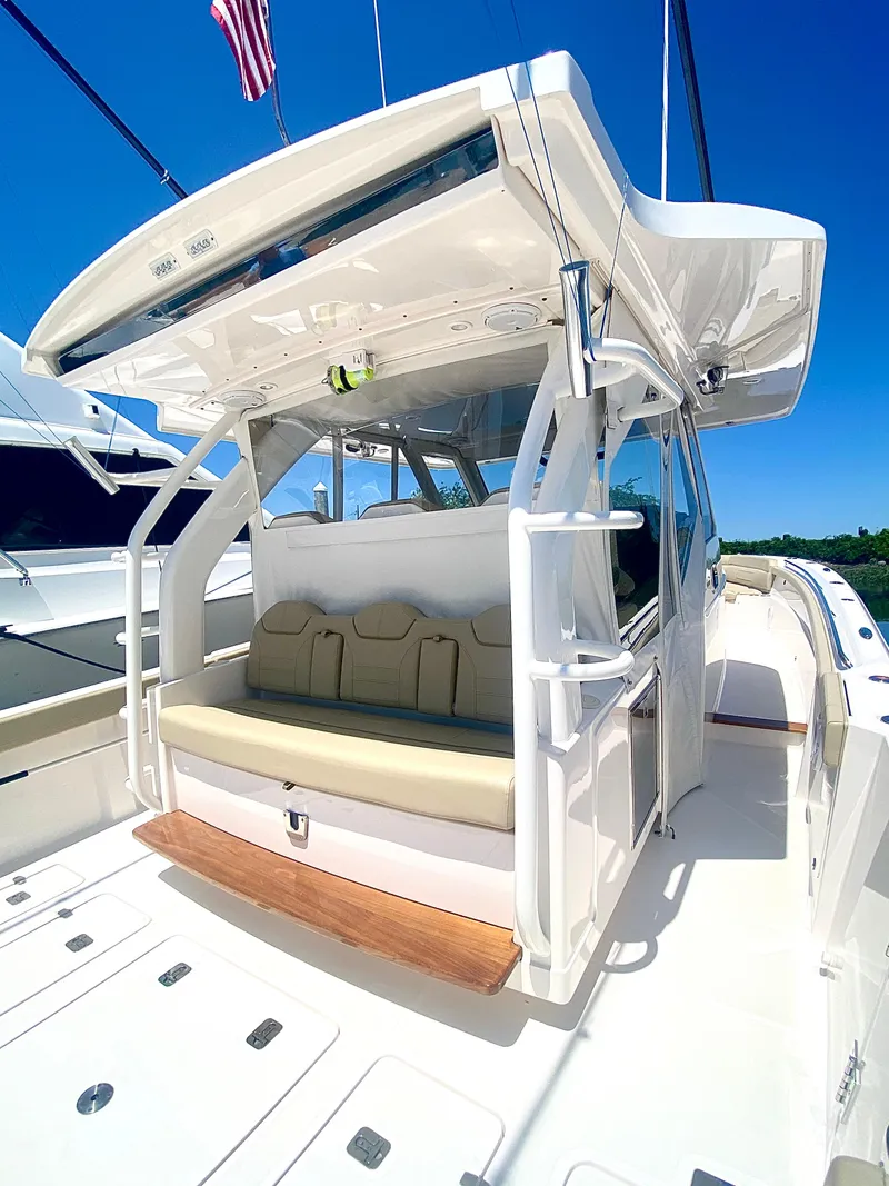 Slide: The Image of 2019 Pursuit S 408 Sport boat with seating, under clear blue sky. - 30