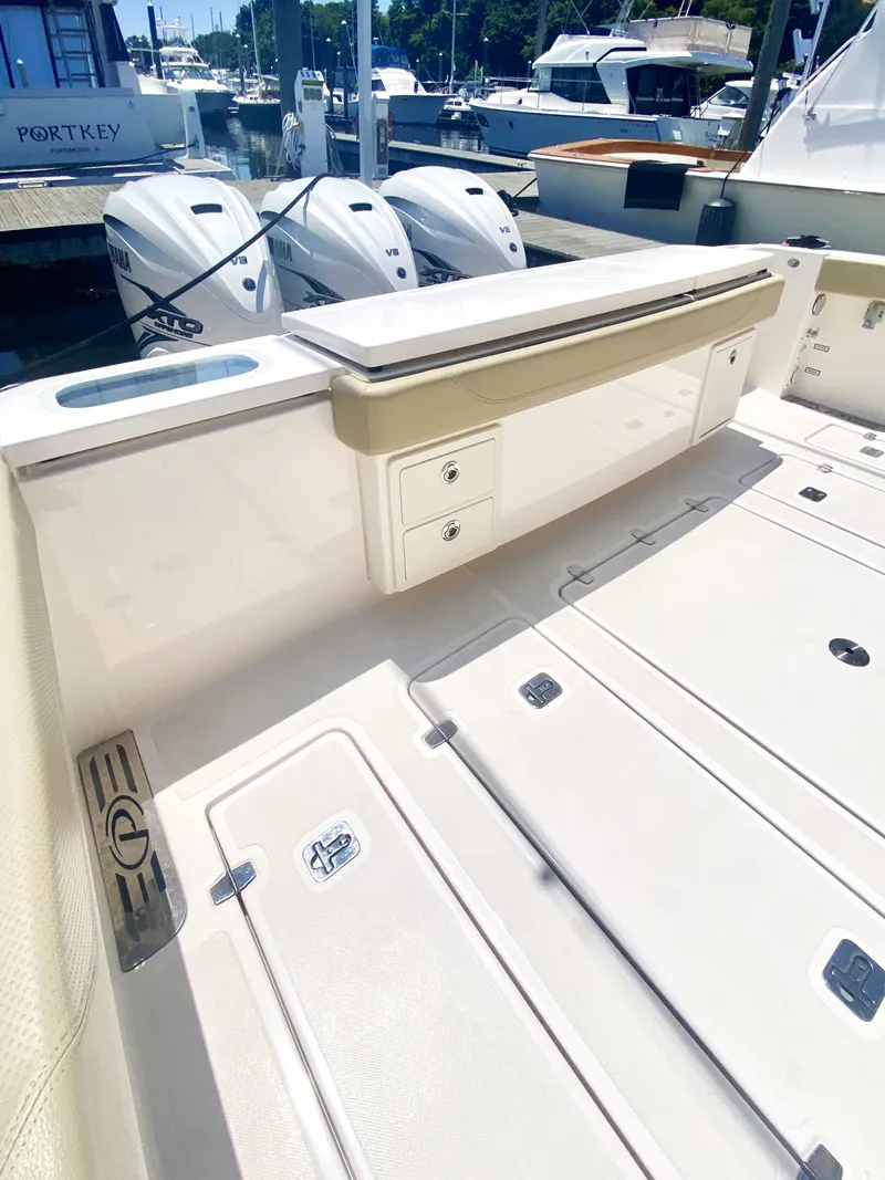 Slide: The Image of 2019 Pursuit S 408 Sport boat deck with storage compartments and outboard motors. - 32