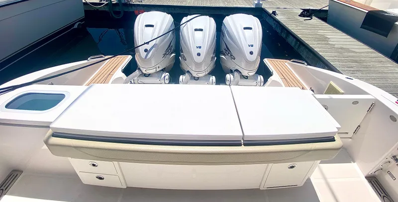 Slide: The Image of 2019 Pursuit S 408 Sport boat with triple outboard engines at dock. - 33