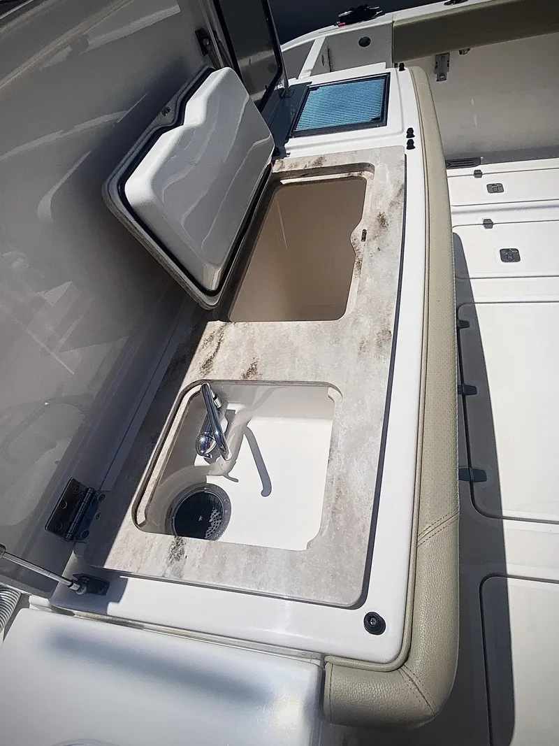 Slide: The Image of 2019 Pursuit S 408 Sport boat sink and storage area. - 34