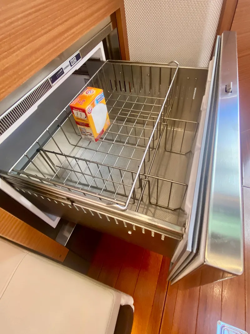 Slide: The Image of Open drawer with a box of baking soda on a Pursuit S 408 Sport boat, 2019 model. - 39