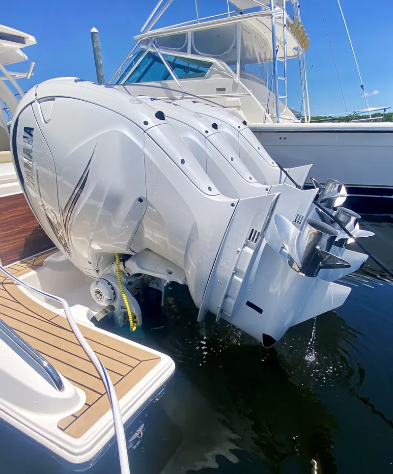 Slide: The Image of 2019 Pursuit S 408 Sport boat with powerful outboard engines at a marina. - 4