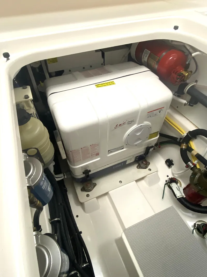 Slide: The Image of Engine compartment of 2019 Pursuit S 408 Sport boat, featuring generator and safety equipment. - 45
