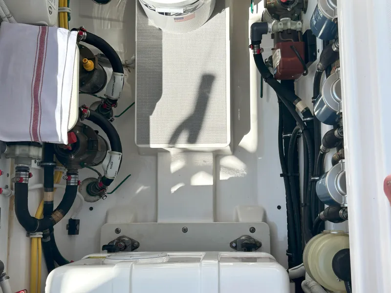 Slide: The Image of Engine compartment of a 2019 Pursuit S 408 Sport boat, showcasing mechanical components and wiring. - 46