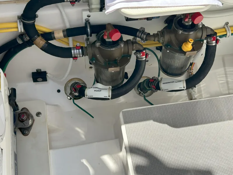 Slide: The Image of Engine compartment of 2019 Pursuit S 408 Sport boat with visible hoses and filters. - 47