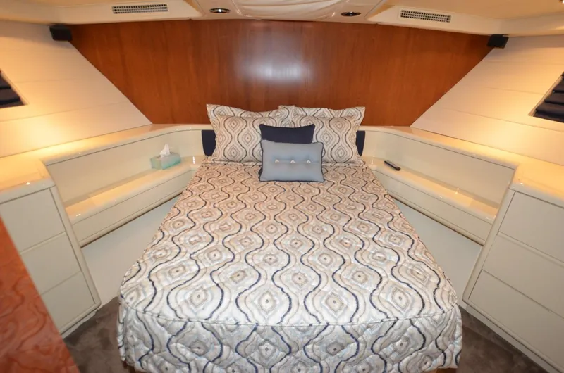 Slide: The Image of Luxurious bedroom interior of 1996 Hatteras 82 Convertible yacht with patterned bedding. - 26