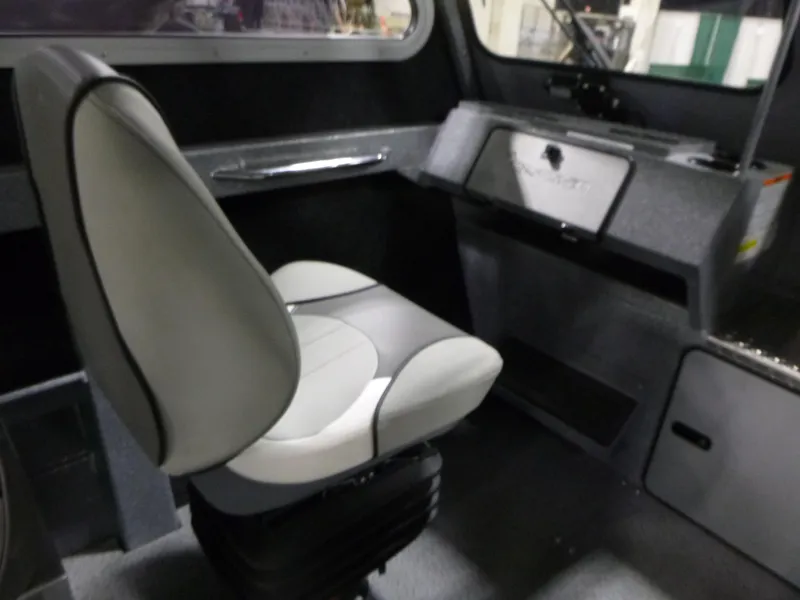 Slide: The Image of Interior of 2025 KingFisher Escape HT boat, featuring a modern captain's chair and dashboard. - 15