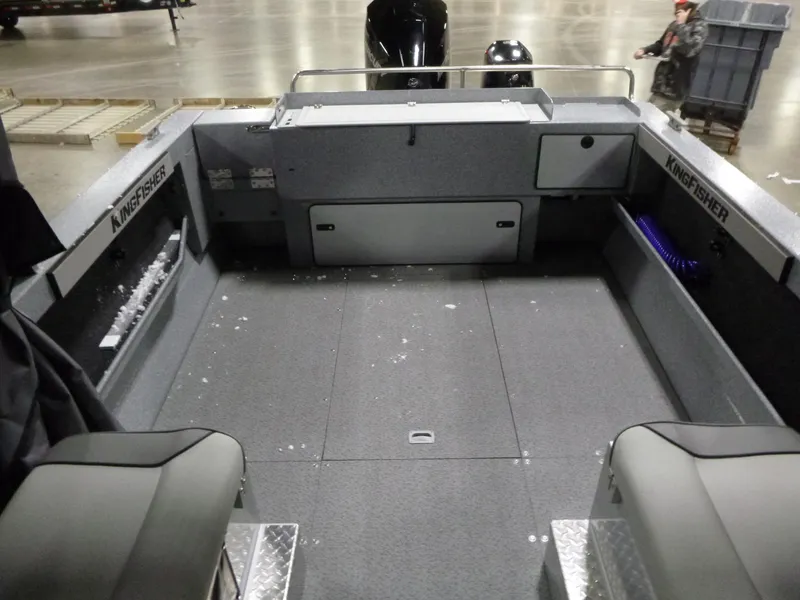 Slide: The Image of 2025 KingFisher Escape HT boat interior, spacious deck, modern design, gray upholstery. - 17