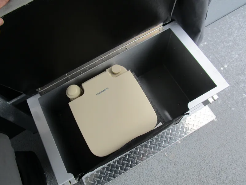 Slide: The Image of Storage compartment with portable toilet in KingFisher 2025 Escape HT boat. - 18