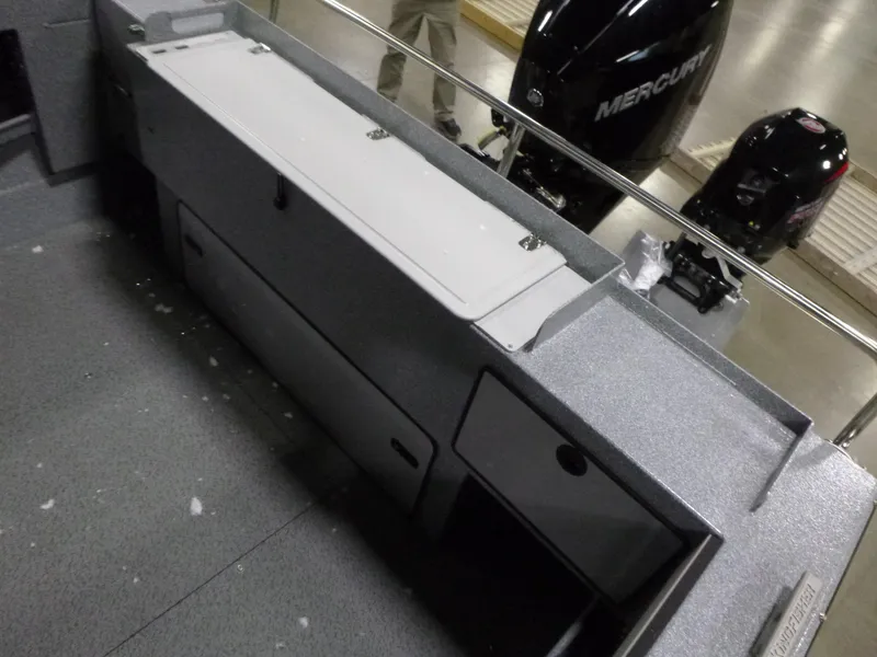Slide: The Image of Interior view of 2025 KingFisher Escape HT boat with storage compartments and Mercury engine. - 19