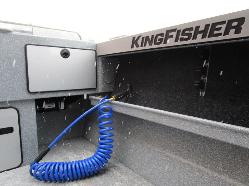 Slide: The Image of KingFisher 2025 Escape HT boat interior with storage and blue coiled hose. - 20