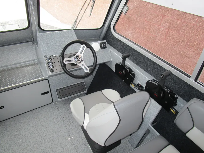 Slide: The Image of Interior of 2025 KingFisher Escape HT boat with steering wheel and controls. - 34