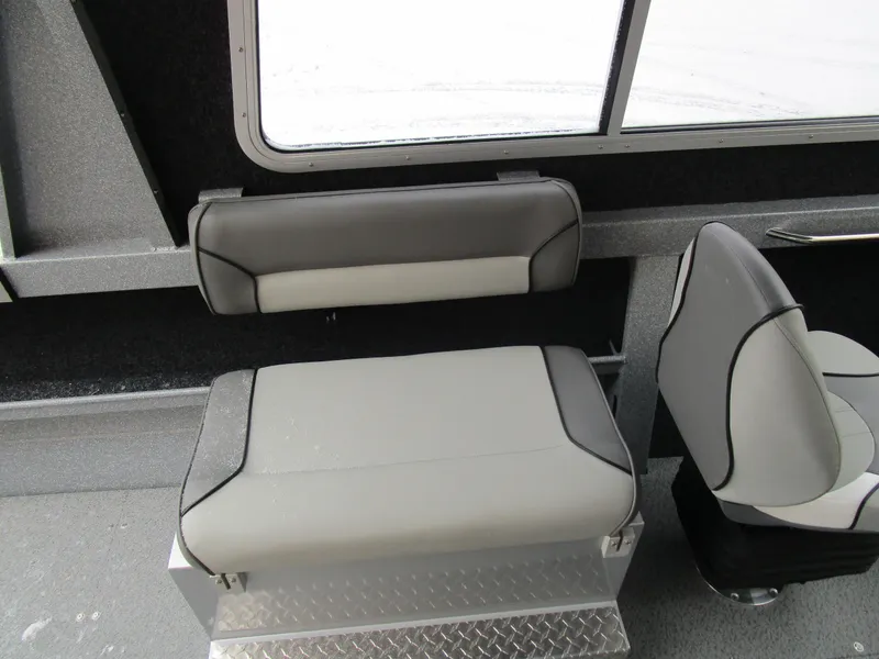 Slide: The Image of KingFisher 2025 Escape HT boat interior with gray seating and window view. - 35
