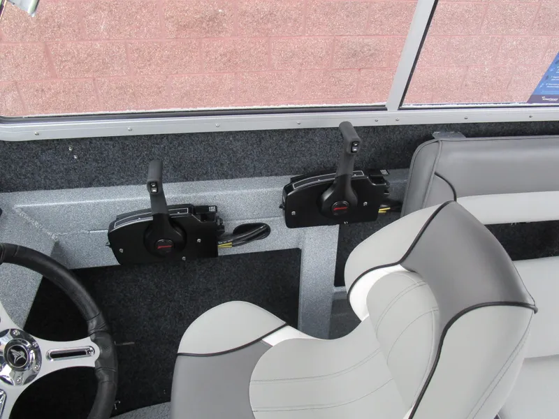 Slide: The Image of Interior of 2025 KingFisher Escape HT boat with steering wheel and controls. - 38