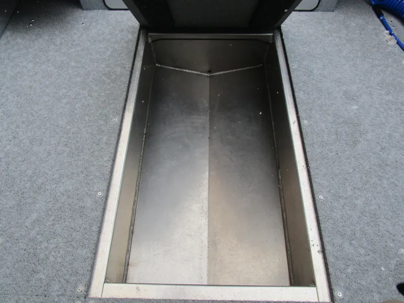 Slide: The Image of KingFisher 2025 Escape HT boat storage compartment with carpeted flooring. - 39