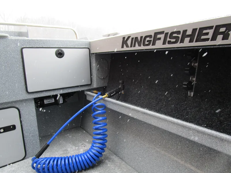Slide: The Image of Interior of 2025 KingFisher Escape HT boat with storage and coiled blue hose. - 40