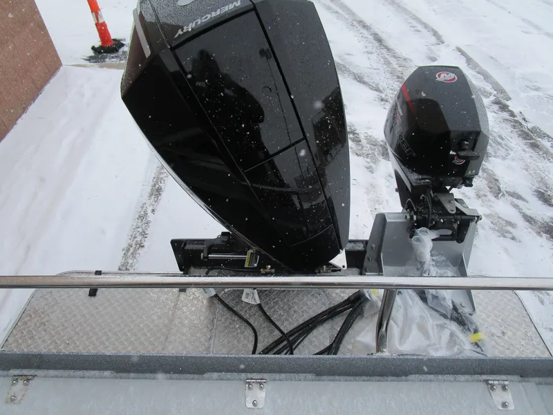 Slide: The Image of KingFisher 2025 Escape HT boat with dual outboard motors in snowy setting. - 42