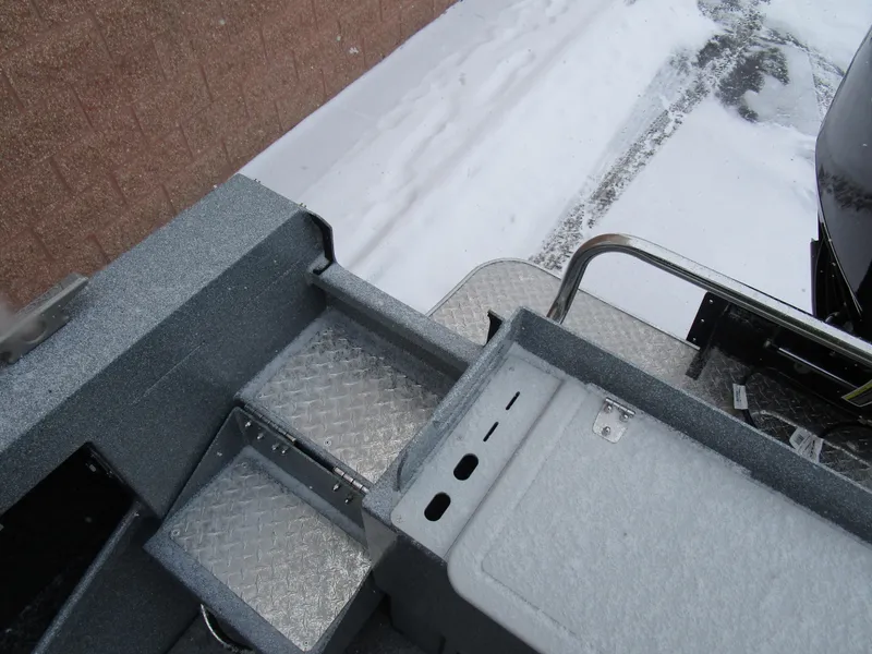 Slide: The Image of KingFisher 2025 Escape HT boat deck with snow-covered steps and railing. - 43