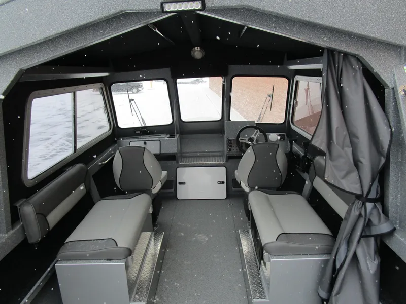 Slide: The Image of Interior of 2025 KingFisher Escape HT boat, featuring seating and steering area. - 44