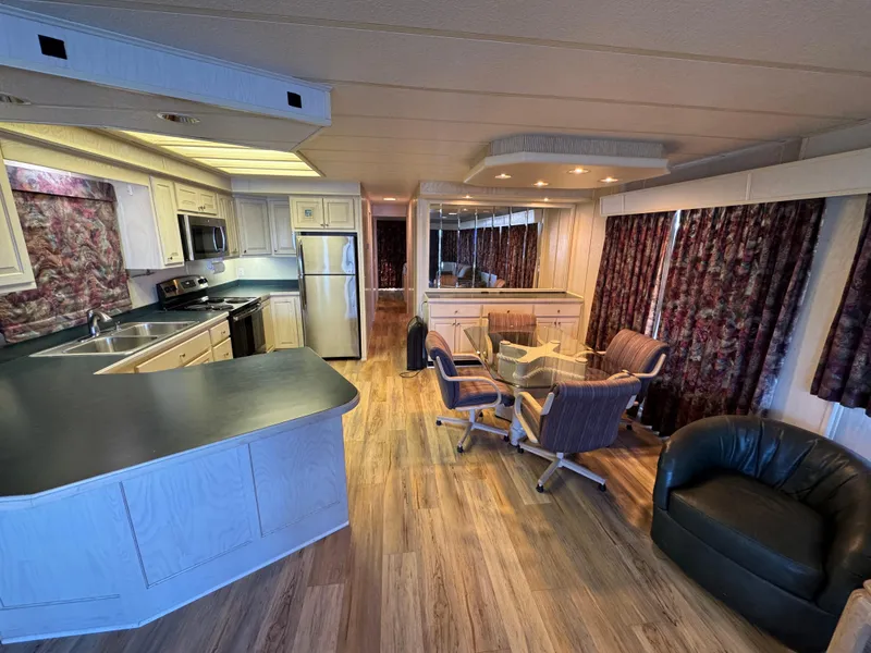 Slide: The Image of Interior of 1996 Stardust Cruisers 72x16 houseboat with modern kitchen and cozy seating area. - 19