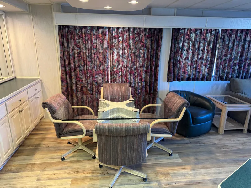 Slide: The Image of Interior of 1996 Stardust Cruisers houseboat with dining area and floral curtains. - 20