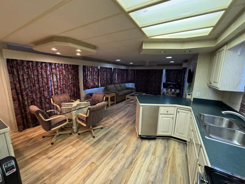 Slide: The Image of Interior of a 1996 Stardust Cruisers 72x16 houseboat with modern kitchen and cozy seating area. - 22