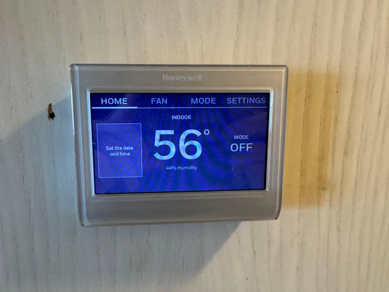 Slide: The Image of Honeywell thermostat displaying 56°F on a 1996 Stardust Cruisers 72x16 houseboat. - 27