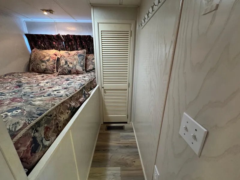 Slide: The Image of Cozy bedroom in 1996 Stardust Cruisers 72x16 houseboat with floral bedding and wood accents. - 28