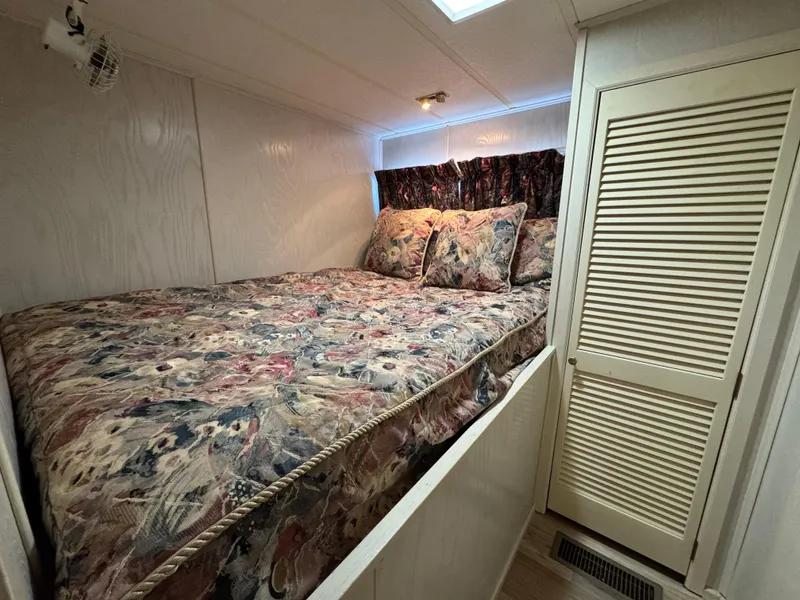 Slide: The Image of Cozy bedroom in 1996 Stardust Cruisers 72x16 houseboat with floral bedding. - 29