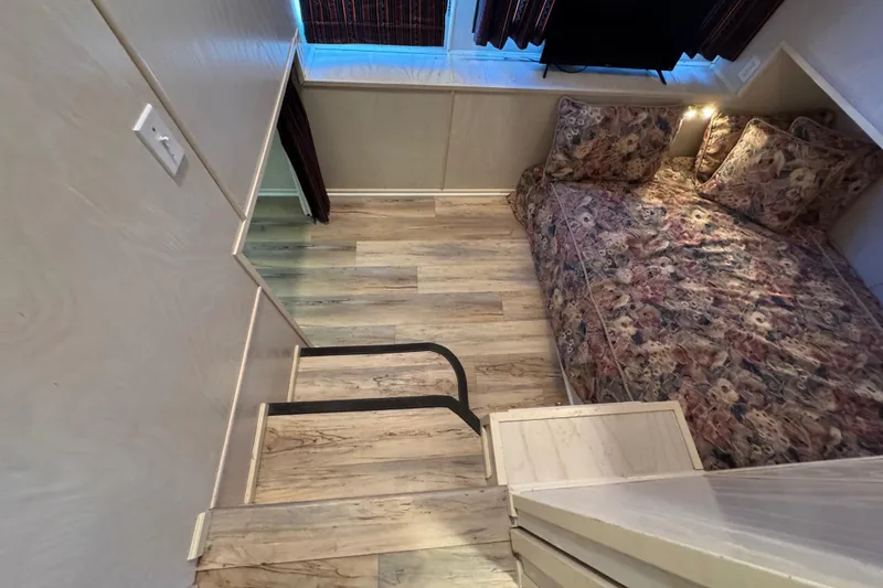 Slide: The Image of Cozy bedroom in 1996 Stardust Cruisers 72x16 houseboat with floral bedding and wood flooring. - 30