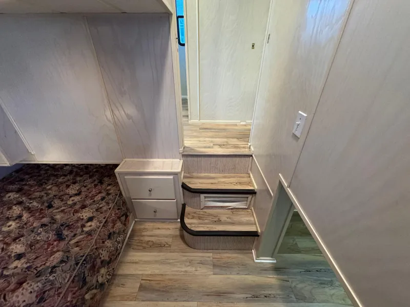 Slide: The Image of Interior of 1996 Stardust Cruisers 72x16 houseboat with stairs and wood flooring. - 31