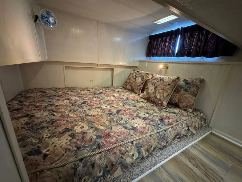 Slide: The Image of Cozy bedroom in 1996 Stardust Cruisers 72x16 houseboat with floral bedding. - 35