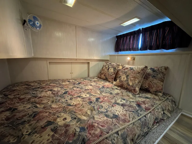 Slide: The Image of Cozy bedroom in 1996 Stardust Cruisers 72x16 houseboat with floral bedding. - 36