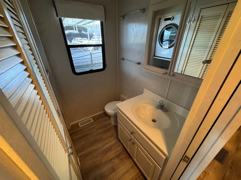 Slide: The Image of Bathroom interior of 1996 Stardust Cruisers 72x16 houseboat with sink, mirror, and window. - 37