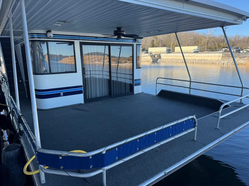 Slide: The Image of 1996 Stardust Cruisers 72x16 houseboat with spacious deck and sliding glass doors. - 4