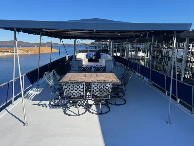 Slide: The Image of 1996 Stardust Cruisers 72x16 houseboat with spacious deck and outdoor seating. - 9