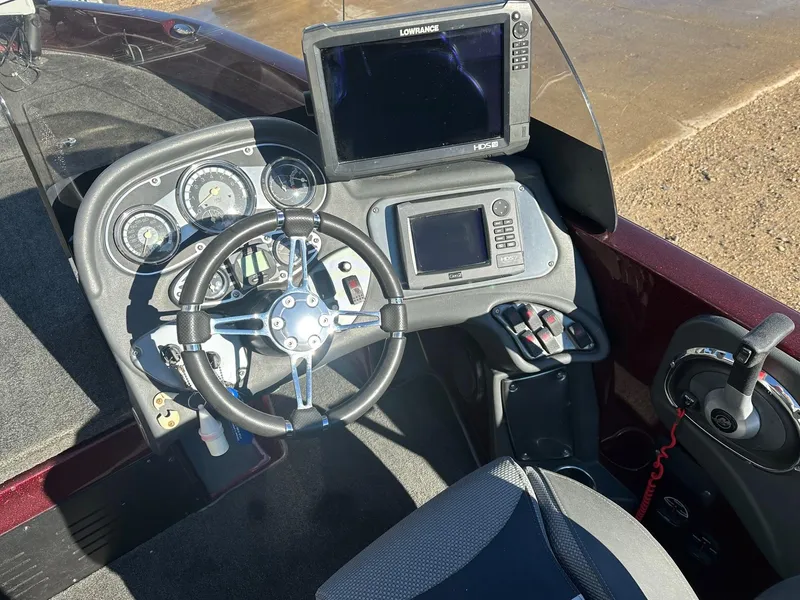 Slide: The Image of 2012 Ranger 619VS boat dashboard with steering wheel, gauges, and Lowrance electronics. - 11