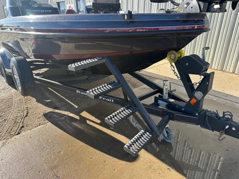 Slide: The Image of 2012 Ranger 619VS boat on trailer, parked outdoors, with visible steps and hitch. - 14
