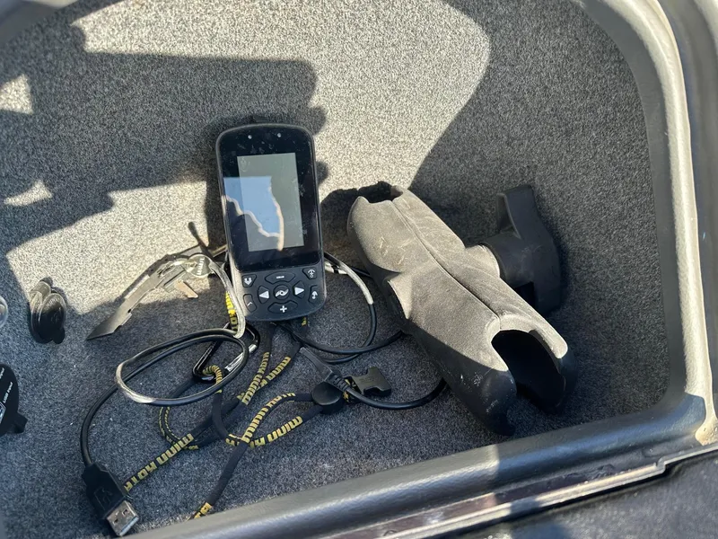 Slide: The Image of 2012 Ranger 619VS storage compartment with GPS device and cables. - 26