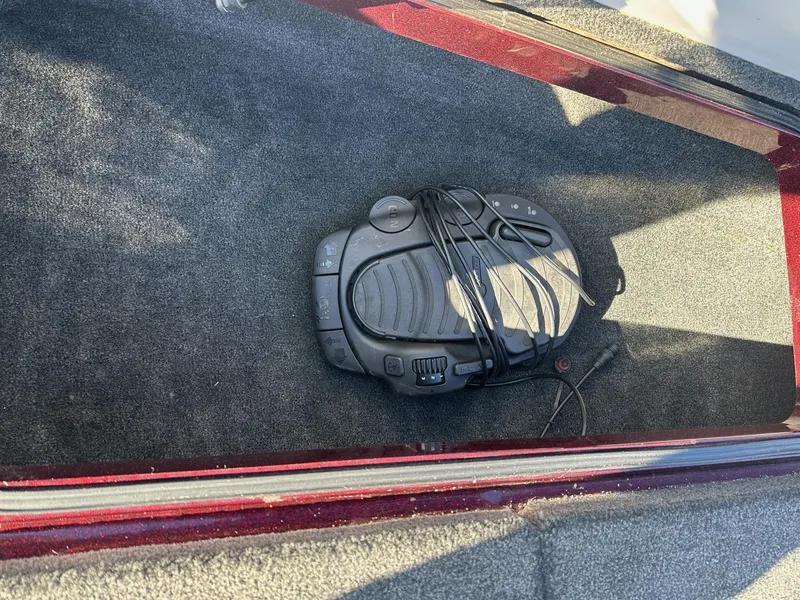 Slide: The Image of Foot pedal in a 2012 Ranger 619VS boat compartment, on dark carpet. - 32