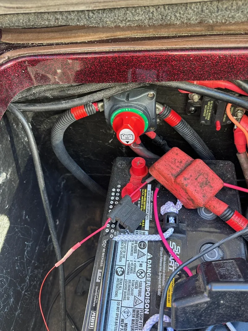 Slide: The Image of Battery compartment of a 2012 Ranger 619VS boat with wiring and connections. - 33
