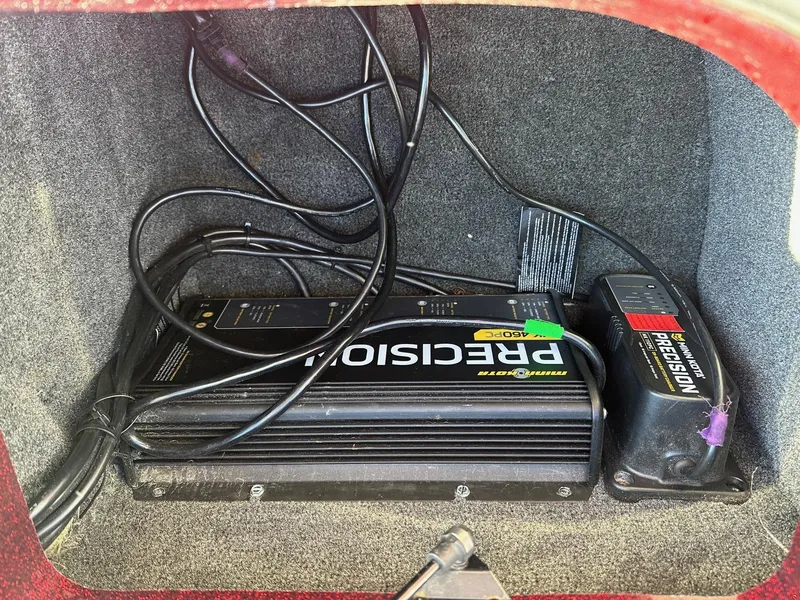 Slide: The Image of 2012 Ranger 619VS boat compartment with Minn Kota Precision battery charger and cables. - 34