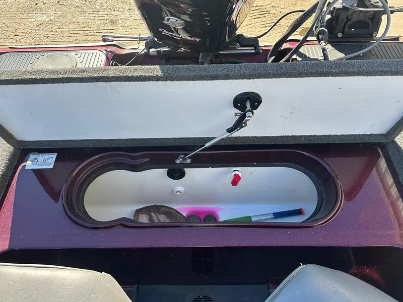 Slide: The Image of Open storage compartment in a 2012 Ranger 619VS boat, showing interior details and equipment. - 35