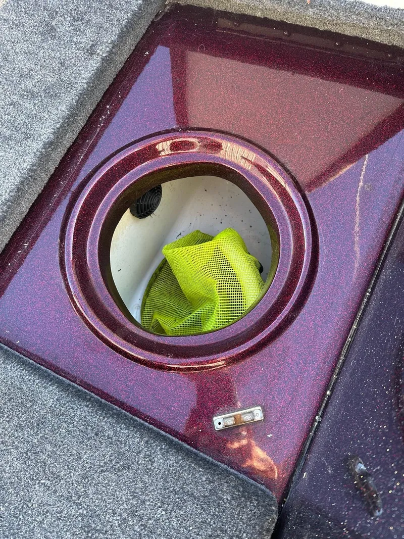 Slide: The Image of Open storage compartment in 2012 Ranger 619VS boat with yellow mesh bag inside. - 36