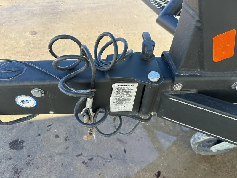 Slide: The Image of Trailer hitch of 2012 Ranger 619VS with coiled safety cables and warning label. - 39