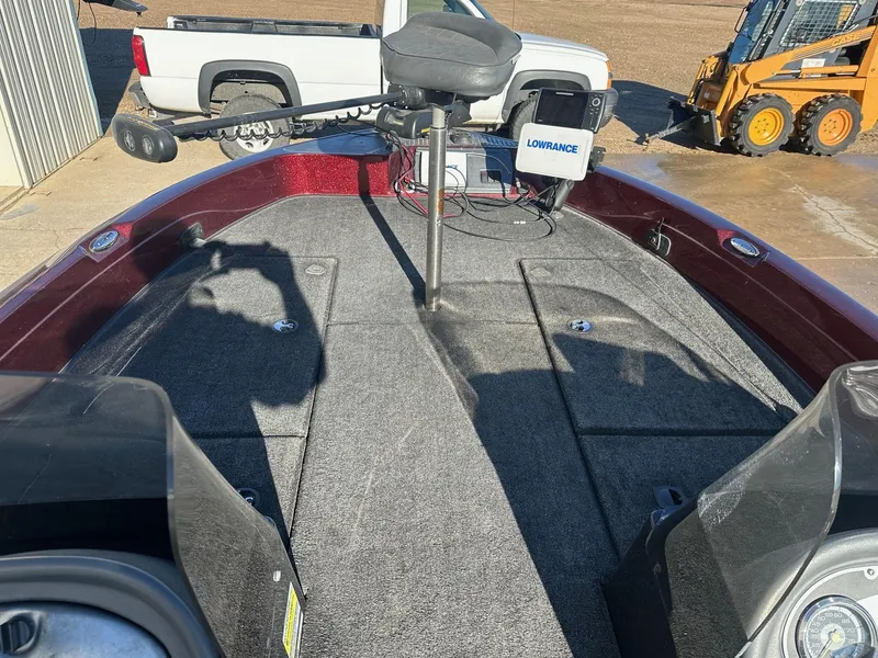 Slide: The Image of 2012 Ranger 619VS boat deck with Lowrance equipment, parked near vehicles and construction machinery. - 4